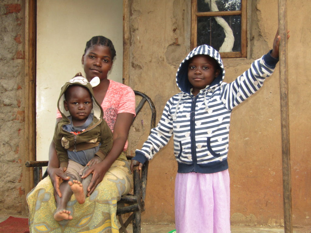 Glory with her mum at their house. Glory attends Life Child Moyo preschool in Malawi.