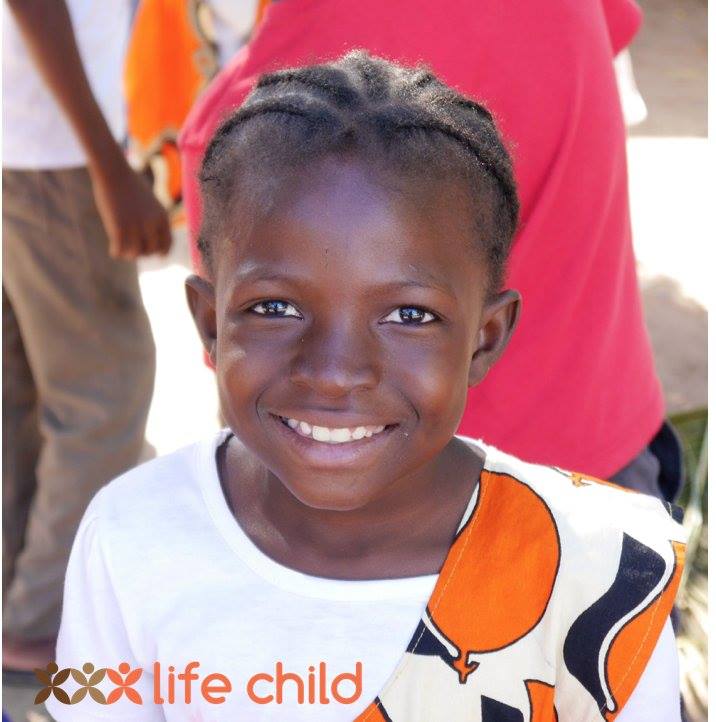 A girl from Life Child school smiling in the camera