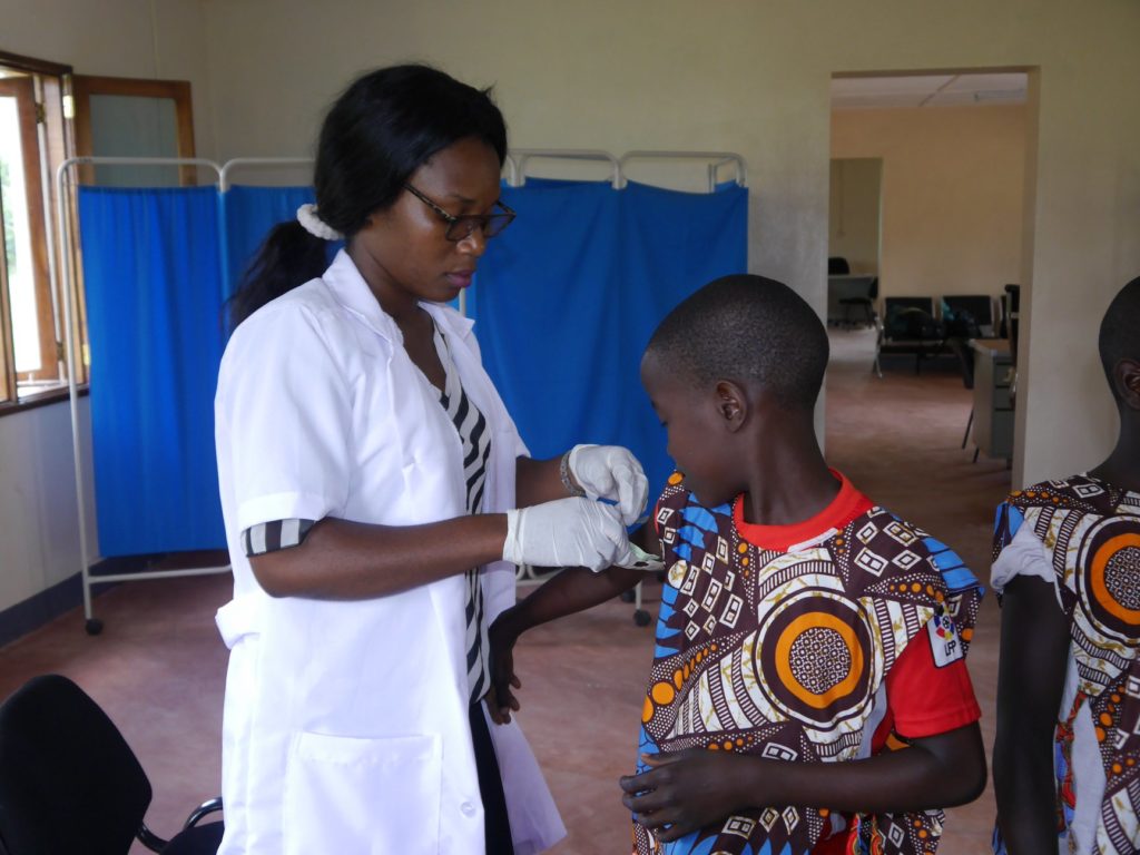 A boy from Peace school in Mozambique receiving a vaccination