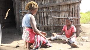 Janete and her mom outside their home in Mozambique